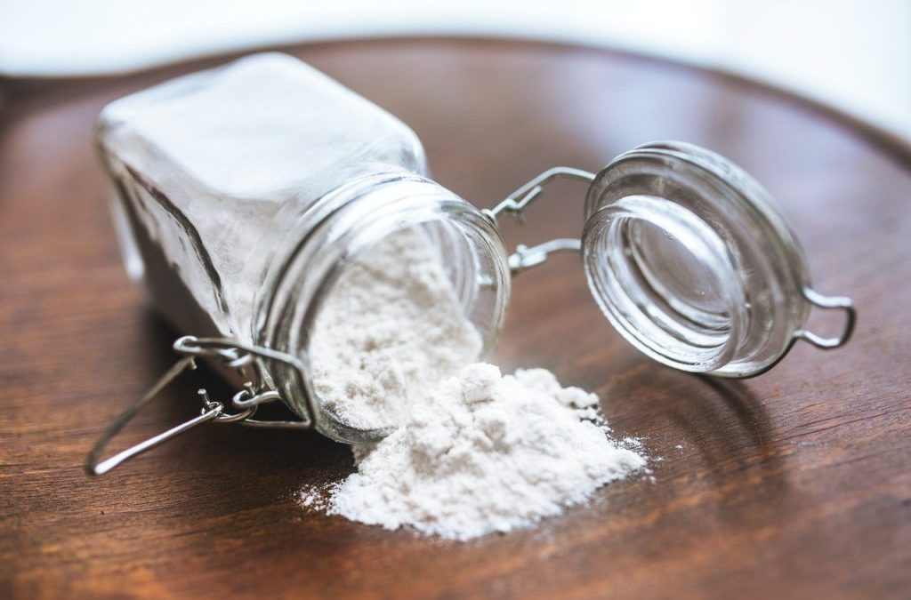 Is white flour bad for you? With image of a jar of flour spilled on a table.