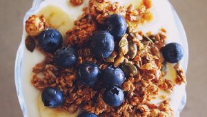 Granola with greek yogurt a healthier breakfast items free from processed carbohydrates.
