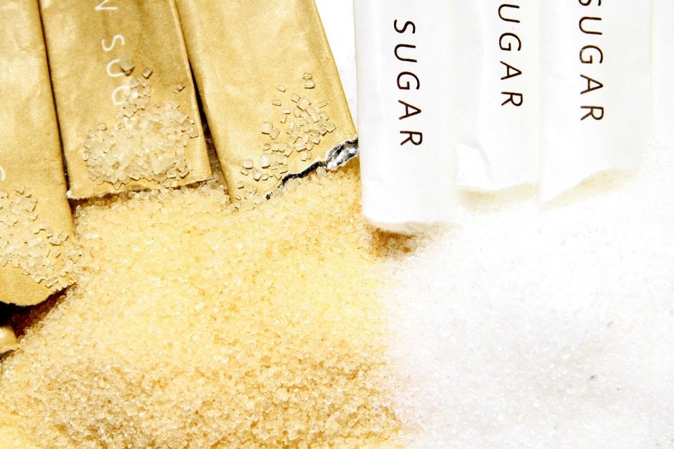 An image of sugar coming out of sugar packets to show how sugar has taken over, and is leading to sugar pains.