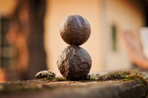 Two rocks balancing to represent a healthy balance, and the fact that all wellness changes help with this balance.
