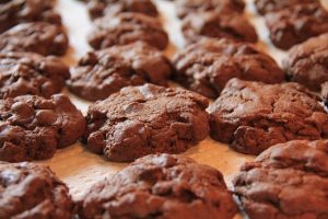 How to bake healthier cookies with an image of chocolate cookies.