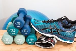 An image of weights, tennis shoes, and an exercise ball to talk about how exercising and being in good shape won't keep you from getting a chronic illness.