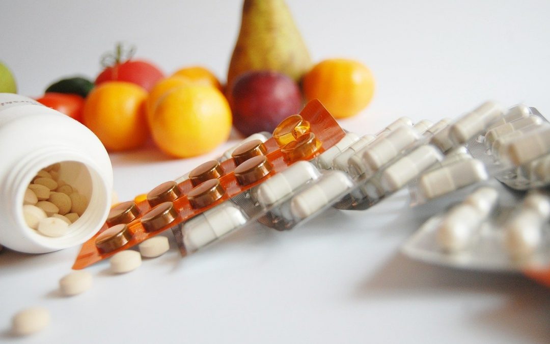 An image of pills and fruits to discuss a cure vs treatment, the difference and the problems with cures.