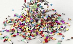 An image of a pile of colorful pills to discuss how we rely too much on modern medicine and there are more natural solutions for our health issues.