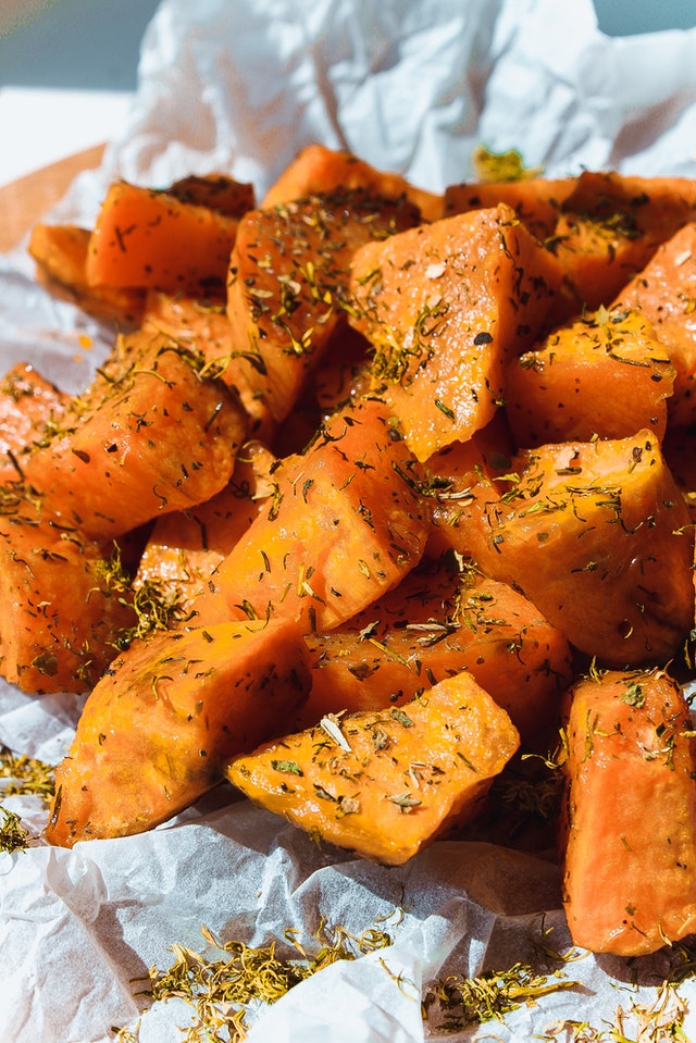 An image of sweet potatoes cut up with spices to talk about its benefits as a superfood and the essential vitamins and minerals in contains.