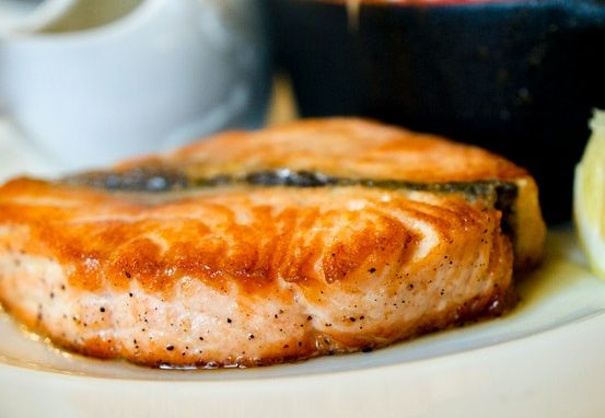 to An image of salmon on a plate to talk about its benefits as a superfood and the essential vitamins and minerals in contains.