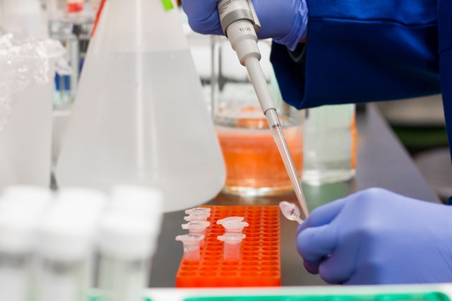 An image of a person in a lab combining ingredients to represent how many supplements are made synthetically in a lab and have many safety concerns.