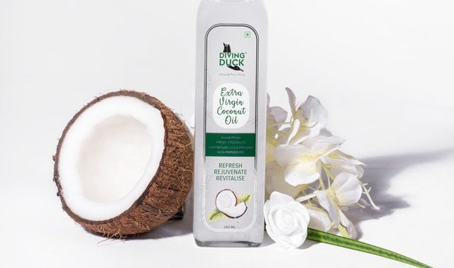 An image of a coconut and coconut oil to talk about its benefits as a superfood and the essential vitamins and minerals in contains.