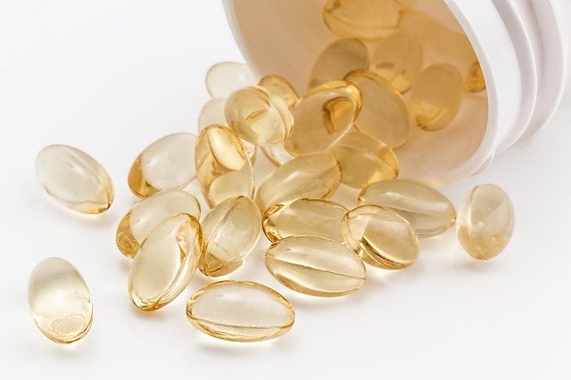 An image of Vitamin D capsules spilling out of a bottle to discuss the benefits of Vitamin D and how many people are deficient.