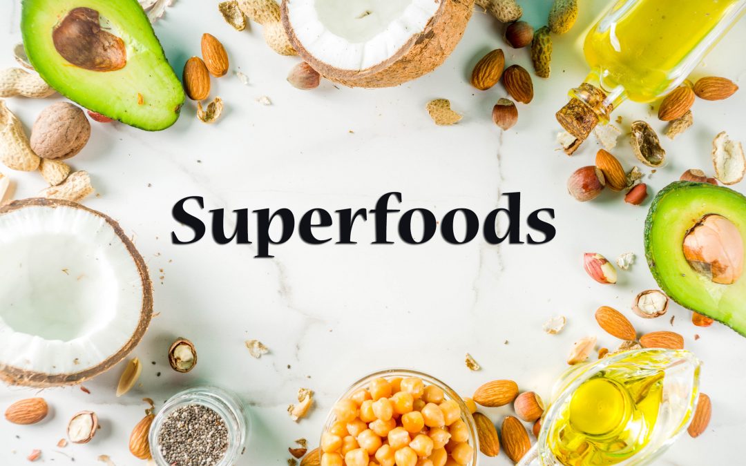 An image of multiple superfoods and the words "Superfoods" in the center to discuss brain superfoods and the benefits of superfoods in general.