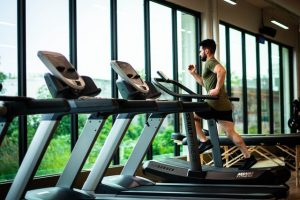 An image of a guy on a treadmill to talk about what cardio is and why it is necessary.