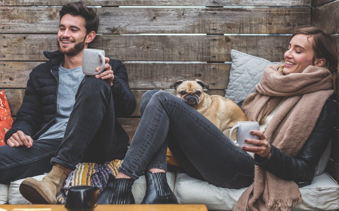 An image of two people drinking coffee relaxing and enjoying one another's company to show what a positive relationship looks like.