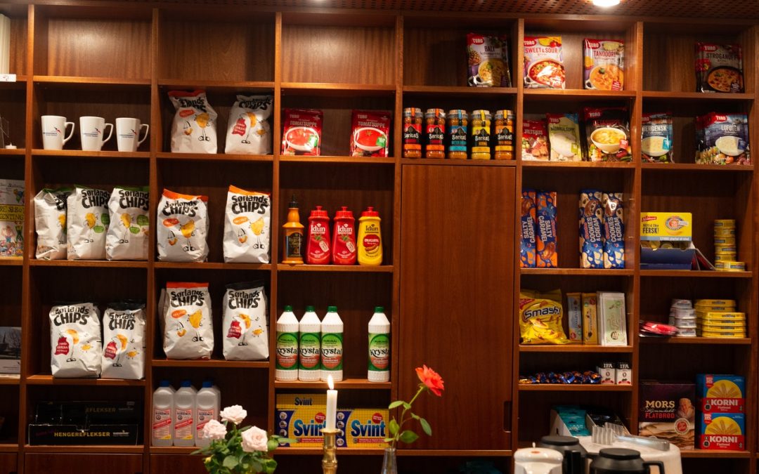 8 Tips on How to Stop Eating Junk Food with an image of junk food lining some wooden shelves.