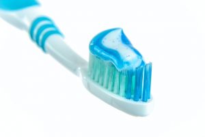 An image of a toothbrush with toothpaste to talk about the dangerous ingredients found in toothpaste.