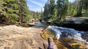 An image of my feet sitting by a waterfall to talk about finding my life purpose.