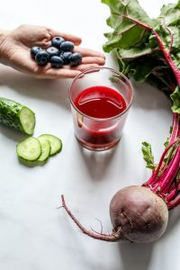 An image of a person creating a juice for detoxing to talk about different methods for detoxing the body.