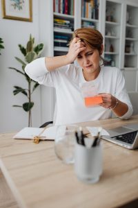An image a of woman stressed our over her finances because she owns too many things (has too much clutter in her life). 
