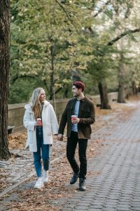 An image of two people walking in a park to talk about the importance of communicating feelings, needs, and boundaries in relationships.