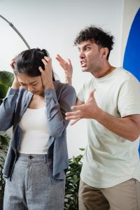 An image of a person getting extremely angry with another person, to talk about how to heal from unhealthy communication in a relationship that caused trauma. 