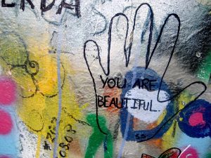 A piece of artwork with the words "you are beautiful" on it to talk about the benefits of feeling better about yourself.