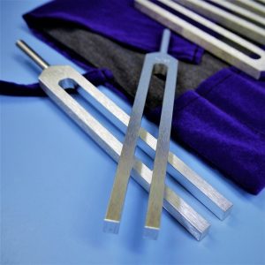 An image of tuning forks to talk about how sometimes a person may need to clear trauma out of their energy field in order to improve their self-esteem. 