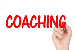An image of the word "coaching" to talk about how coaches can help with adopting healthier behavior patterns.