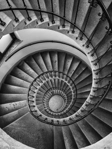 An image of a spiral staircase to represent how the mind spirals when people struggle with obsessive ruminating. 