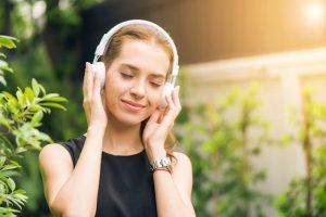 An image of a person listening to music to talk about how it can help a person focus.