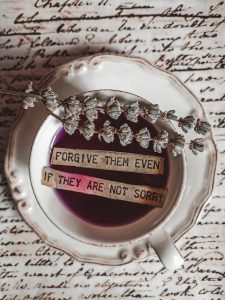 Text in a coffee cup that says "forgive them even if they are not sorry" to talk about how you don't need an apology to forgive.